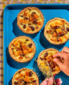 Cabot pairing guide, cheddar tarts on blue baking sheet