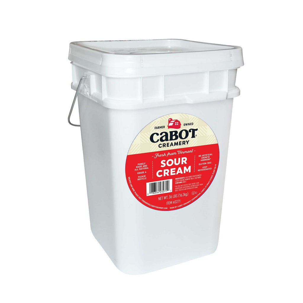 White bucket of Cabot Creamery sour cream on a white background